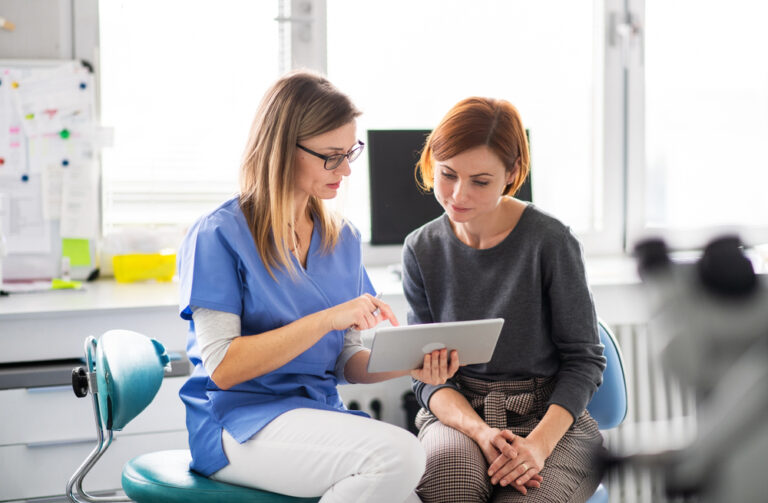 A dentist talking to woman for dental surgery